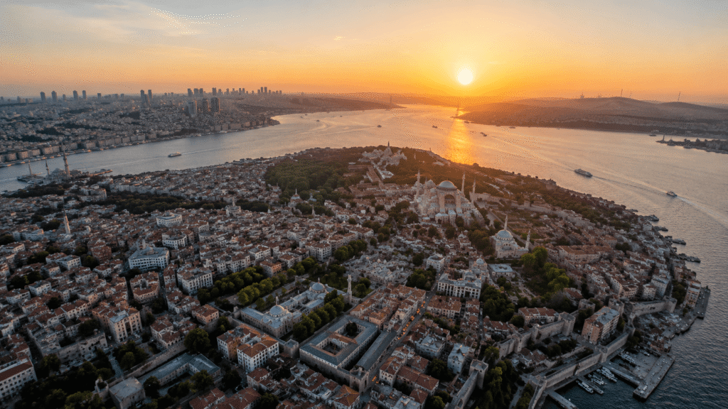 An aerial shot from a helicopter looking down on a city, landscape